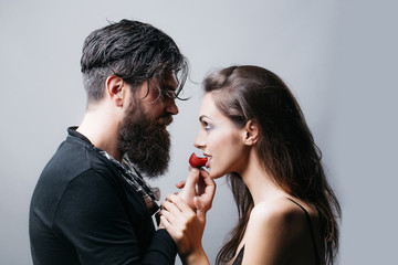 sexy couple eating red strawberry