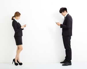 young business man and woman holding smart phone