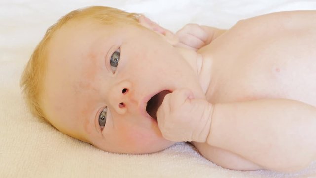 A newborn baby looks and emotes , 5 day