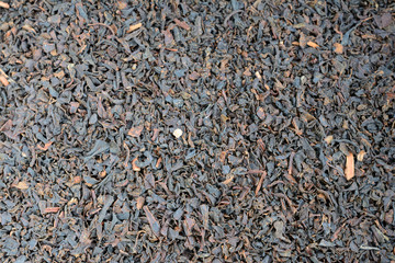 Dry black tea leaves.