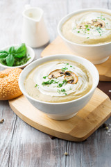 Homemade Mushroom cream soup on a white wooden table