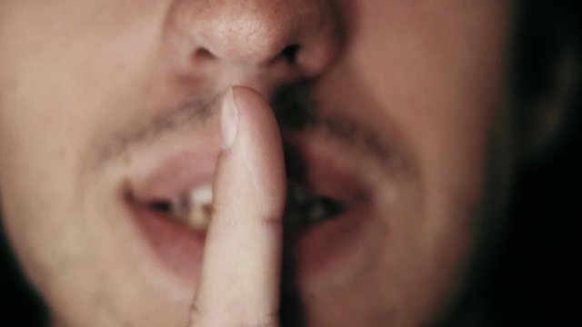 man saying shhh smiling