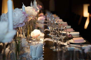 Cutlery Banquet table covered in natural crocodile skin, glasses and plates, forks and knives, napkins and buttons for a luxurious celebration in anticipation of guests. Luxury festive table. 