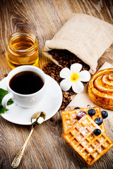 Waffles with berries on wooden background