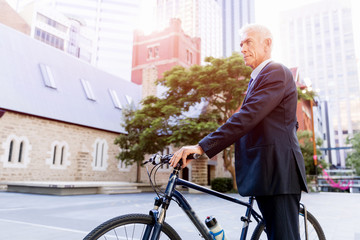 Obraz premium Successful businessman riding bicycle
