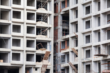 Construction site view of crane, lift, metal beam, brick, metal ladder and concrete