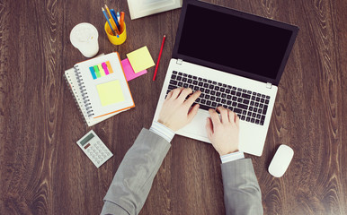 Office workplace with office supplies and laptop