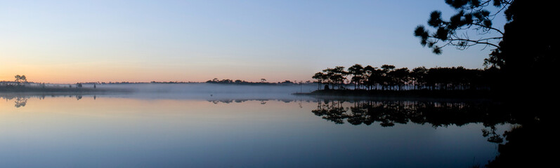 Panorama view of reservoir on sunrise background.