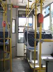 Interior of empty public european city bus without passengers during summer