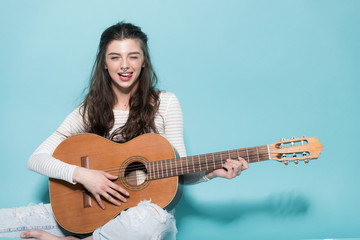 beautiful young girl posing with guitar - 116482250