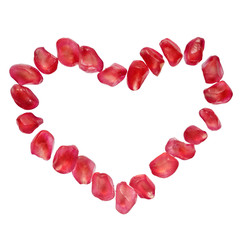 Heart shaped pomegranate seeds isolated on white