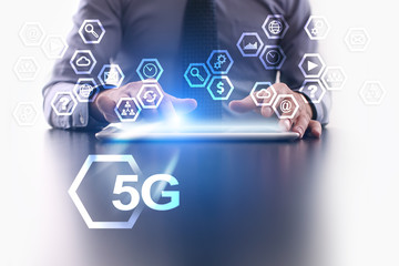 Businessman is using tablet pc and selecting 5G  icon.