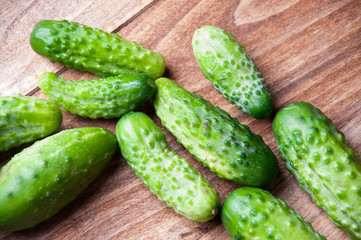 The image of fresh cucumber on a wooden table