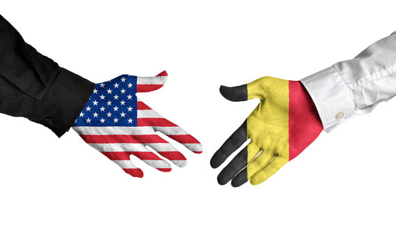 United States and Belgium leaders shaking hands on a deal agreement