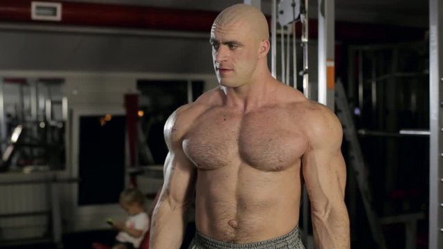 bodybuilder exercising biceps at gym