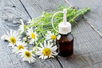 Chamomile essential oil and chamomile flowers