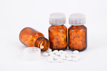 Pills in retro bottle on white background