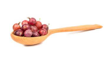 Red gooseberries in spoon