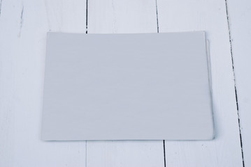 The MockUp of the newspaper on a wood background