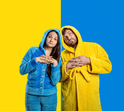 Couple Wearing Blue Pijamas And Yellow Bathrobe