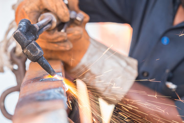 Worker cutting steel using metal torch