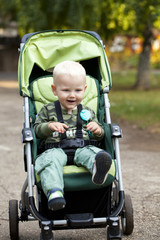 Little boy sitting in stroller