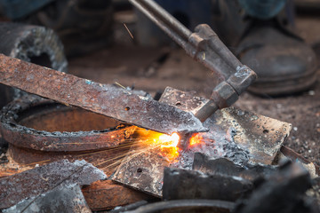 Worker cutting steel using metal torch