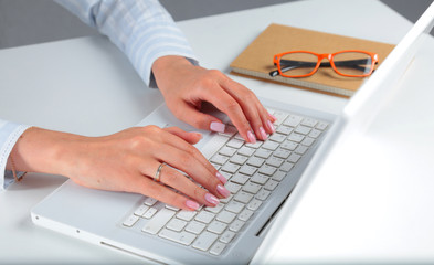 Young pretty business woman with notebook in the office