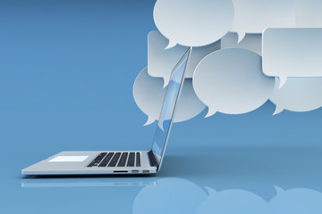 Communication technology, social networking, internet and online messaging concept, white empty speech bubbles and modern laptop computer on blue background with reflection