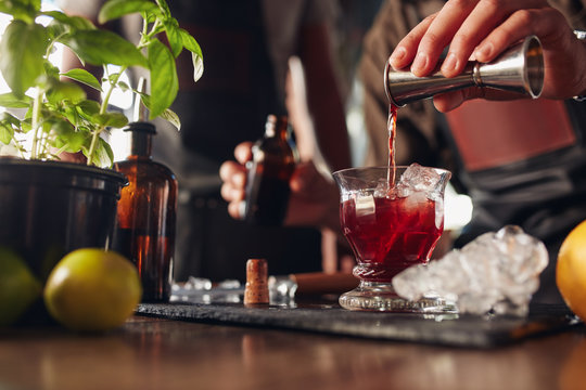 Bartender preparing fresh negroni cocktail