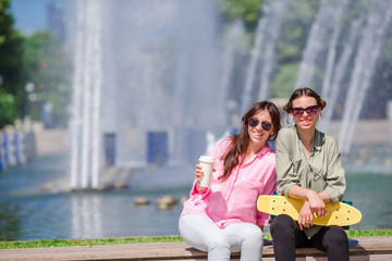 Fototapeta premium Happy young urban girls in european city. Caucasian tourists having fun together outdoors