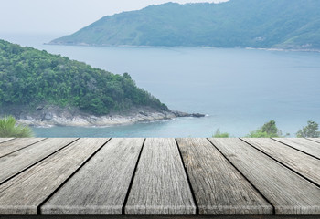 Wood table top on blurred sea and island background, can put you