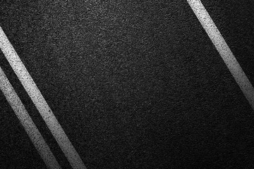 Level asphalted road with a dividing white stripes. The texture of the tarmac, top view.