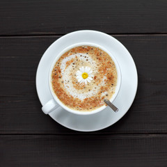 flower Coffee mood/ cup of frothy cappuccino warming decorated camomile top view 