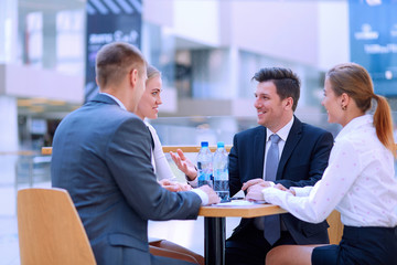Group of happy young business people in a meeting at office