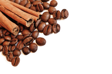 Coffee beans and cinnamon sticks isolated on white. Selective focus