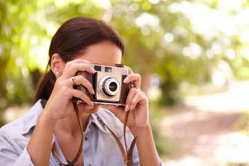 Young female taking photographs with camera