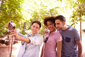 Young threesome posing for a selfie