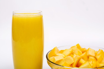 Fresh golden mango served with smoothie on white