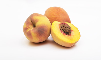 Three peach fruits with leaf isolated on white background