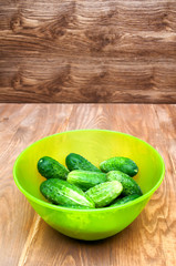 Mini cucumbers in bowl on table