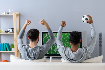 Friends enjoying soccer in TV