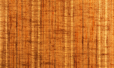 Close-up of a textile surface with orange and brown color