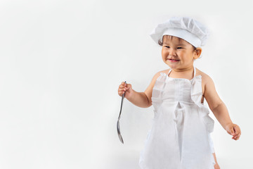 little baby in a chef's hat and ladle in hand