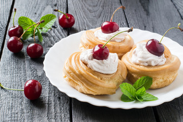Cakes with cream and cherry