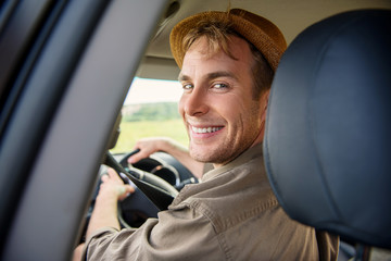 Happy male tourist traveling by transport