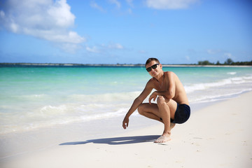 Fototapeta na wymiar A guy on a paradise beach