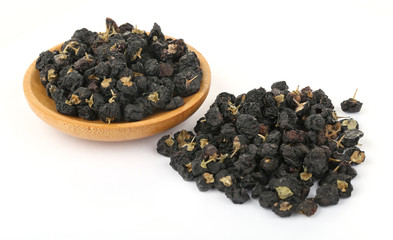 Traditional Chinese  black herbs dried wolfberry close up on a small plate