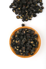 Traditional Chinese  black herbs dried wolfberry close up on a small plate
