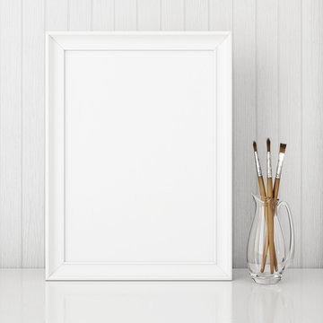 Vertical interior poster mock up with empty white frame and art brushes on wooden background. 3D rendering.